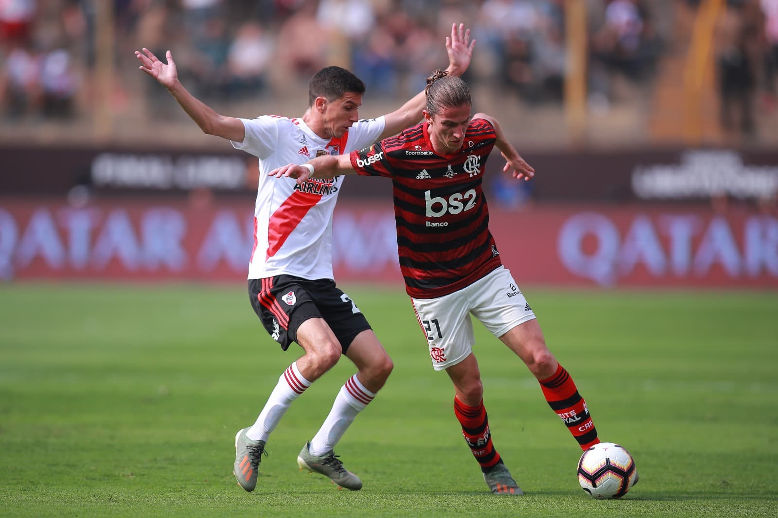 Filipe Luis of Flamengo fights for the ball with Ignacio Fernandez of River Plate during the final match of Copa CONMEBOL Libertadores 2019 between Flamengo and River Plate at Estadio Monumental on November 23, 2019 in Lima, Peru.