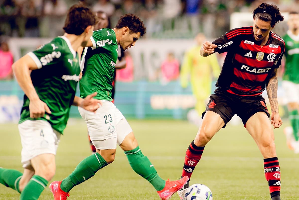 Pedro tenta driblar jogadores do Palmeiras em jogo entre as duas equipes no Brasileirão de 2025